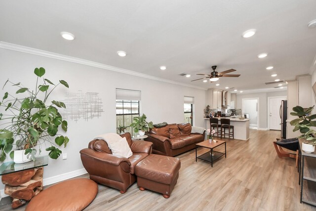 1561 Scharpe St, Houston, TX 77023 - living room with baseboards, recessed lighting, light wood-style floors, and ornamental molding