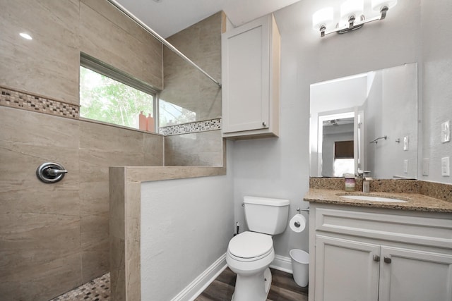 1561 Scharpe St, Houston, TX 77023 - full bathroom featuring toilet, vanity, wood finished floors, and a walk in shower