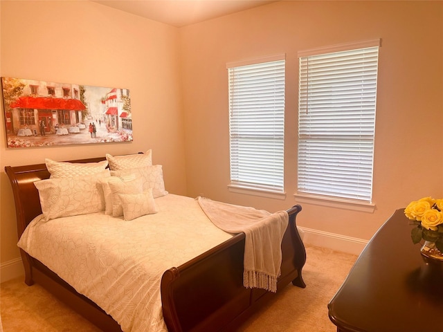 carpeted bedroom featuring baseboards