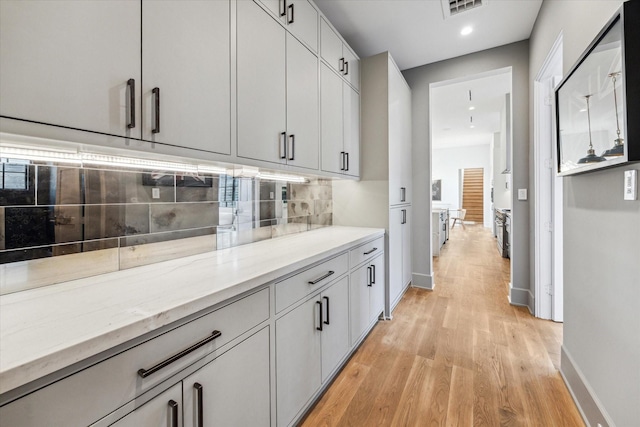2926 Wroxton Rd, West University Place, TX 77005 - bar area featuring light wood finished floors, baseboards, decorative backsplash, and recessed lighting
