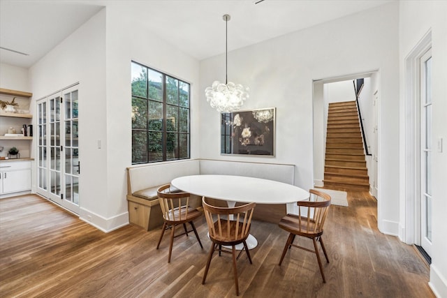 2926 Wroxton Rd, West University Place, TX 77005 - dining space with wood finished floors, breakfast area, stairs, baseboards, and a chandelier