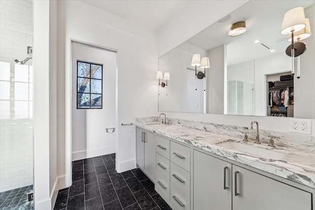 2926 Wroxton Rd, West University Place, TX 77005 - bathroom with double vanity, a shower stall, a spacious closet, tile patterned flooring, and baseboards