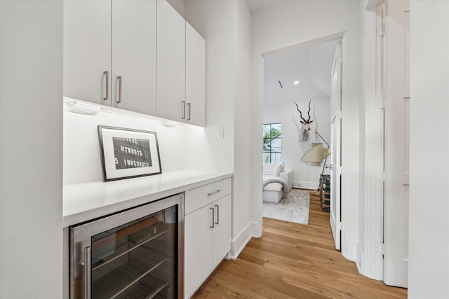 2926 Wroxton Rd, West University Place, TX 77005 - indoor dry bar with wine cooler, light wood-type flooring, and baseboards