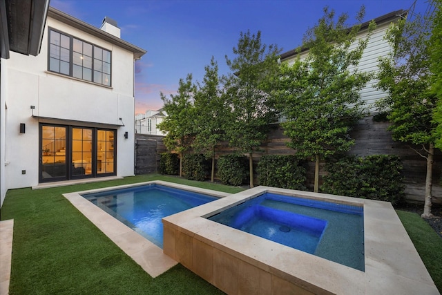 2926 Wroxton Rd, West University Place, TX 77005 - pool at dusk featuring an in-ground hot tub