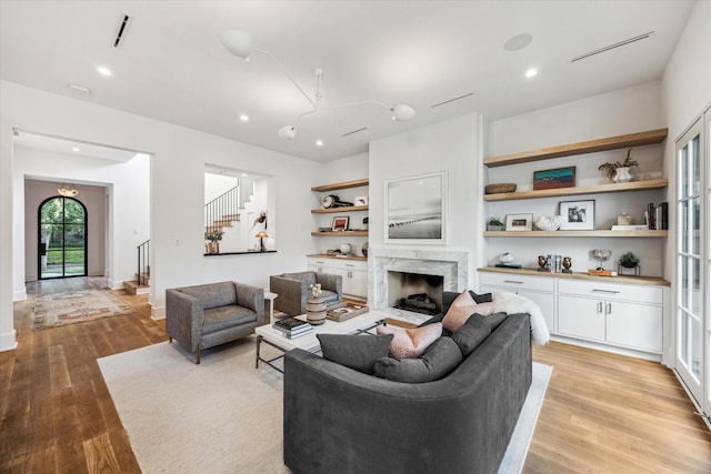 2926 Wroxton Rd, West University Place, TX 77005 - living area featuring stairway, light wood-style floors, a premium fireplace, and recessed lighting