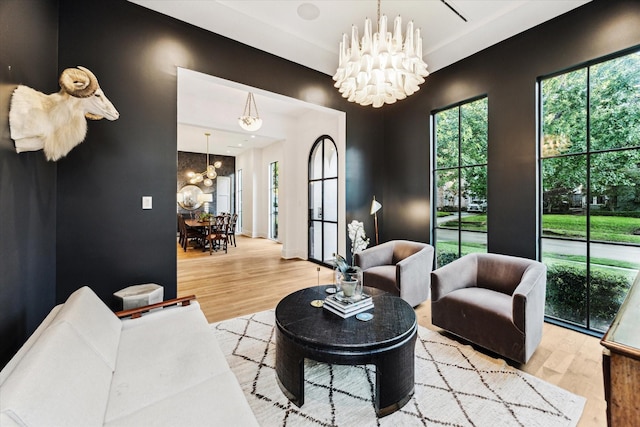 2926 Wroxton Rd, West University Place, TX 77005 - living room with a chandelier and light wood finished floors