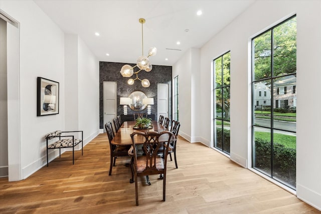 2926 Wroxton Rd, West University Place, TX 77005 - dining area with a chandelier, baseboards, light wood-style flooring, recessed lighting, and an accent wall