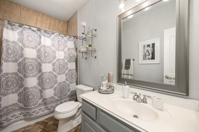 bathroom featuring vanity, toilet, and curtained shower