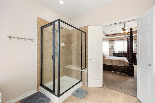 bathroom featuring a ceiling fan, a stall shower, tile patterned floors, baseboards, and connected bathroom