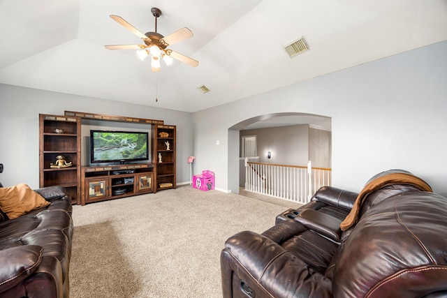 living room with visible vents, a ceiling fan, lofted ceiling, carpet flooring, and arched walkways