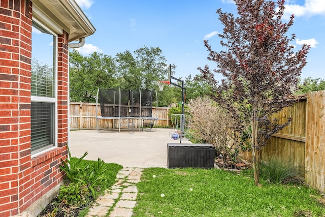 view of patio with a fenced backyard, a trampoline, and central AC