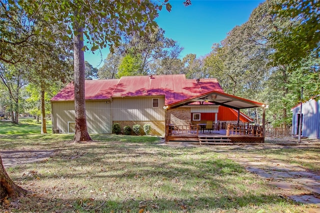 310 Karen Dr, Lufkin, TX 75901 - back of property featuring a yard, a deck, and metal roof