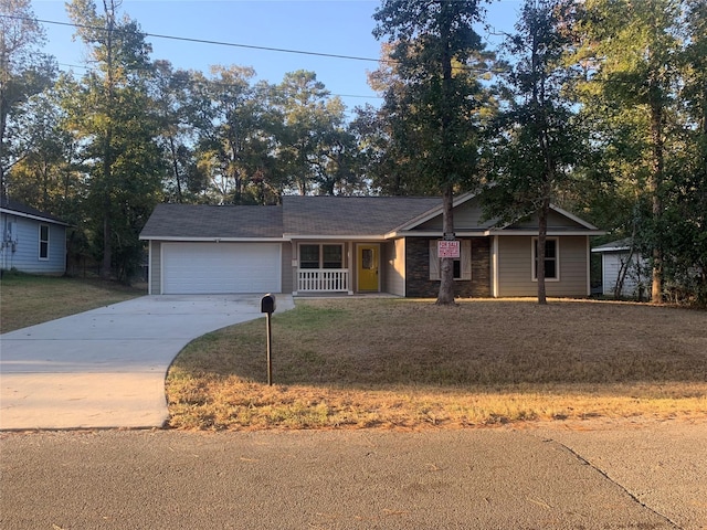 ranch-style house with a garage, a front lawn, covered porch, and concrete driveway