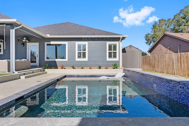 view of swimming pool with a fenced backyard, an outbuilding, a storage shed, and a patio area
