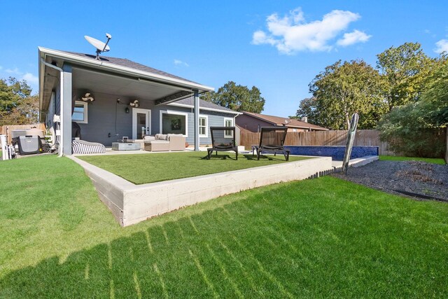 rear view of property with outdoor lounge area and a patio area