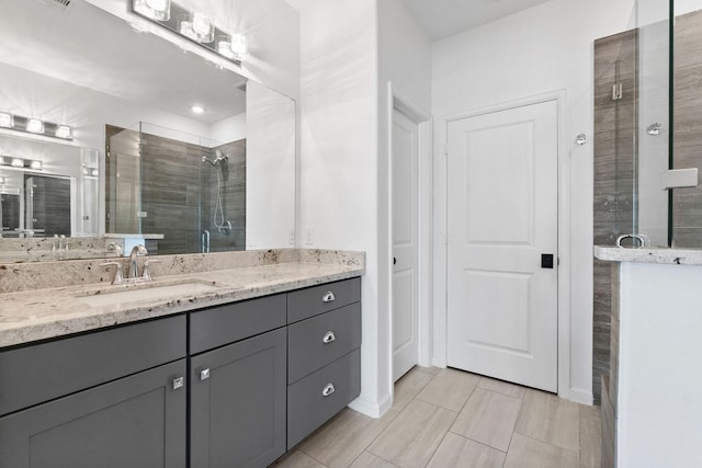 bathroom featuring a shower stall and vanity