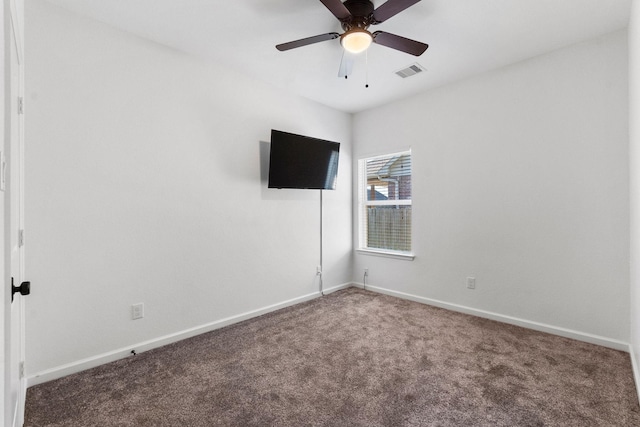 empty room with carpet floors, baseboards, and a ceiling fan
