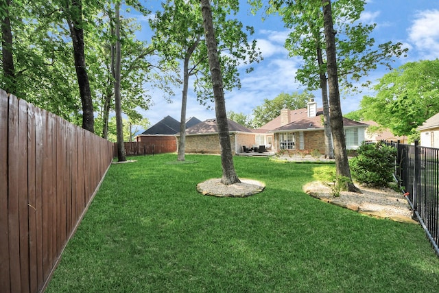 view of yard with a fenced backyard