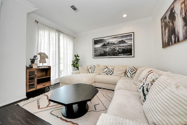 living area with ornamental molding, recessed lighting, wood finished floors, and visible vents
