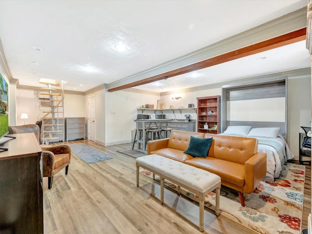 1002 Staples Ave, Seabrook, TX 77586 - living area featuring baseboards, ornamental molding, light wood-style floors, and recessed lighting
