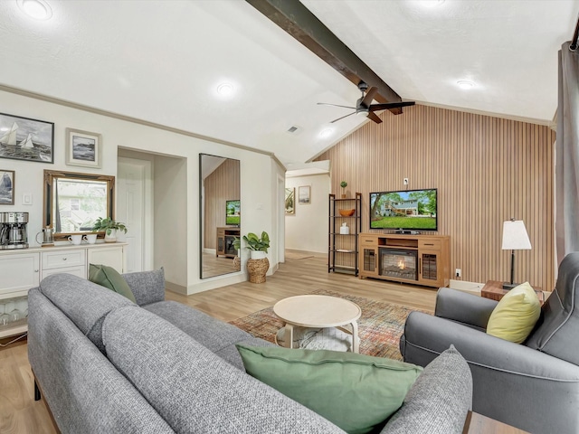 1002 Staples Ave, Seabrook, TX 77586 - living area with light wood finished floors, ceiling fan, and wood walls
