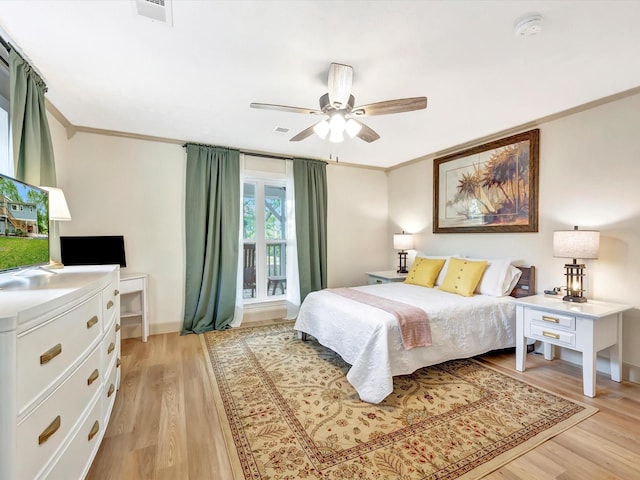 1002 Staples Ave, Seabrook, TX 77586 - bedroom with light wood finished floors, ornamental molding, a ceiling fan, and baseboards