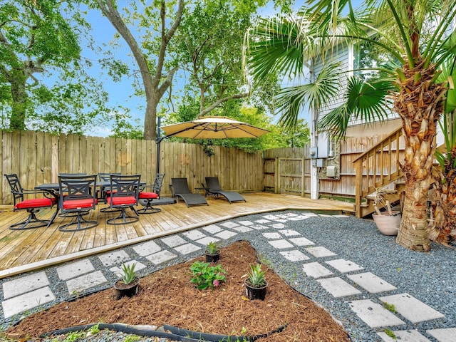 1002 Staples Ave, Seabrook, TX 77586 - fenced backyard with outdoor dining area and a deck