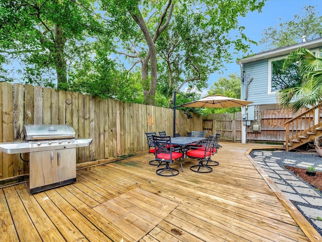 1002 Staples Ave, Seabrook, TX 77586 - wooden terrace featuring a grill, a fenced backyard, outdoor dining space, and stairs