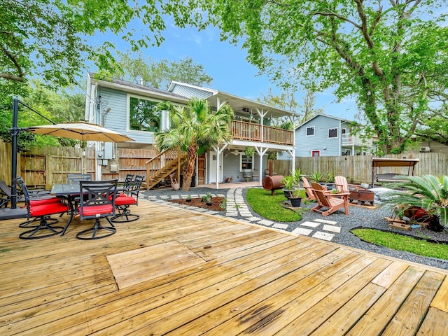1002 Staples Ave, Seabrook, TX 77586 - wooden terrace featuring outdoor dining area, a fenced backyard, an outdoor fire pit, stairs, and a patio