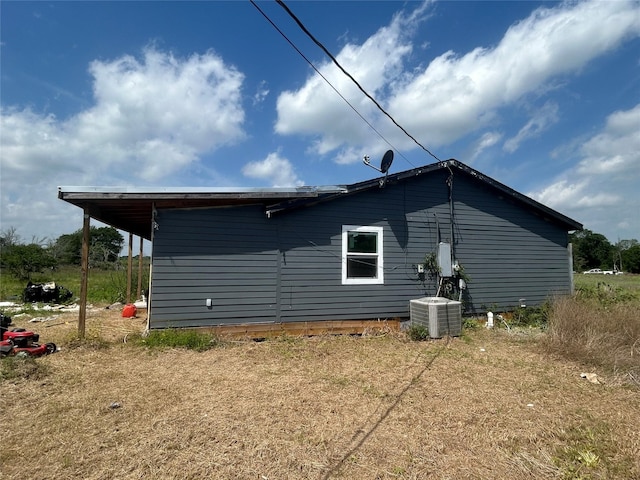 view of side of property with central AC unit
