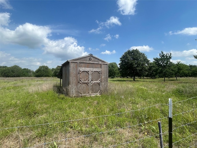 view of shed with a rural view