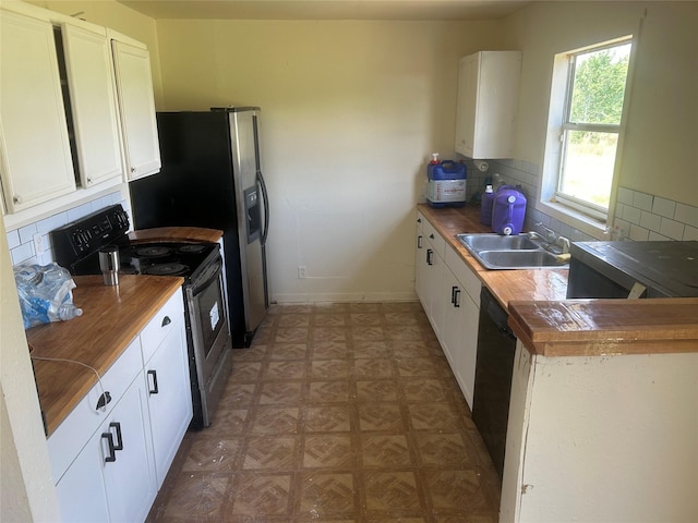 kitchen with water heater, range with electric stovetop, a sink, decorative backsplash, and butcher block countertops