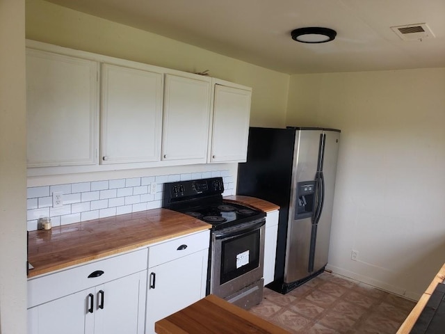 kitchen featuring backsplash, visible vents, white cabinets, and stainless steel appliances