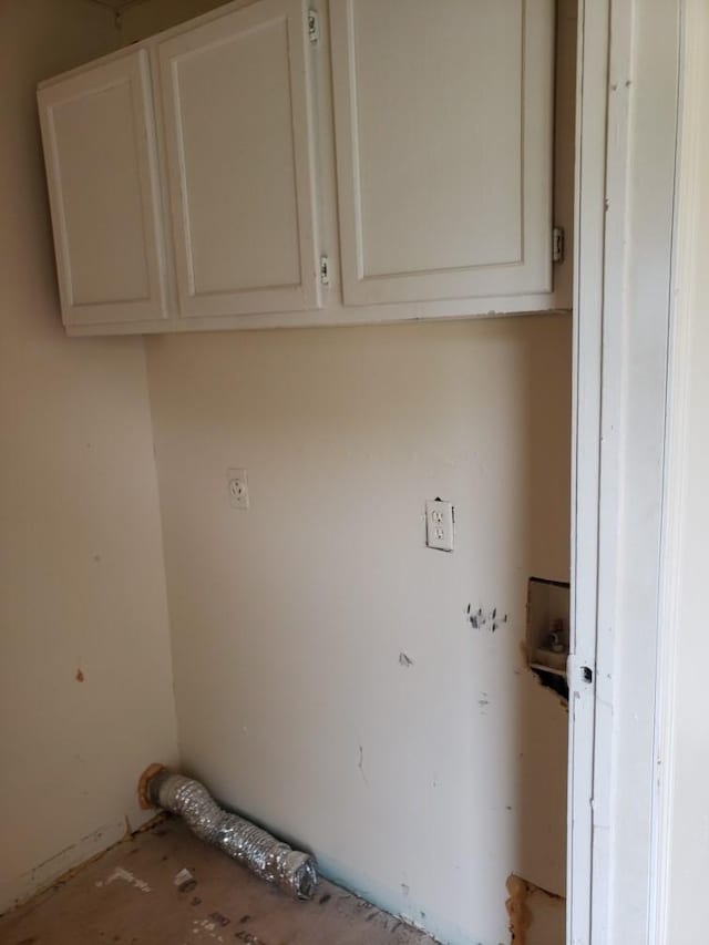 laundry area with hookup for an electric dryer and cabinet space
