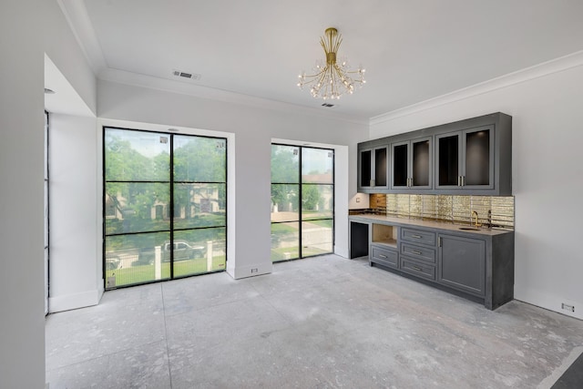 5517 Sturbridge Dr, Houston, TX 77056 - unfurnished living room featuring crown molding, a chandelier, a sink, and baseboards