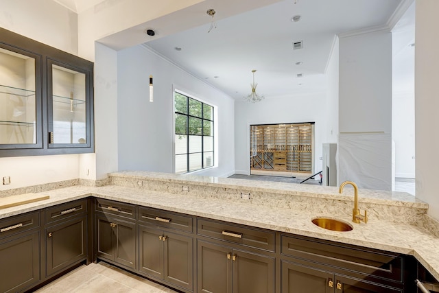 5517 Sturbridge Dr, Houston, TX 77056 - kitchen featuring a sink, light stone countertops, ornamental molding, glass insert cabinets, and dark brown cabinetry
