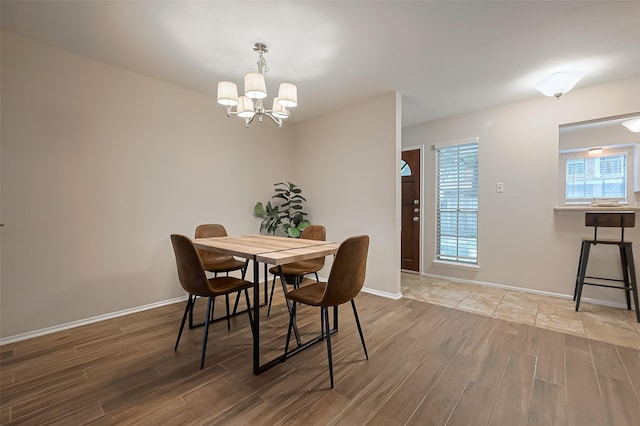 859 Wax Myrtle Ln, Houston, TX 77079 - dining space with baseboards, wood finished floors, and an inviting chandelier
