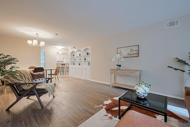 859 Wax Myrtle Ln, Houston, TX 77079 - living area featuring baseboards, wood finished floors, visible vents, and a notable chandelier