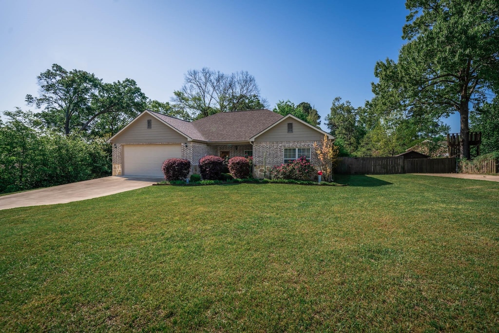 406 E Mari Beth Ln, White Oak, TX 75693 - ranch-style home featuring driveway, an attached garage, fence, a front yard, and brick siding