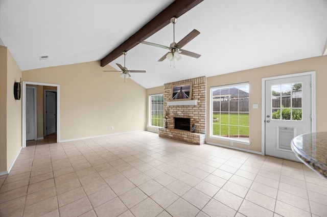 unfurnished living room with a fireplace, a healthy amount of sunlight, a ceiling fan, and lofted ceiling with beams