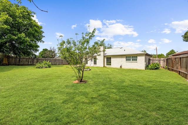 view of yard with a fenced backyard
