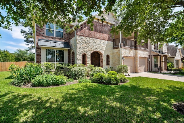 view of front of property featuring fence, a front lawn, a balcony, stone siding, and a garage