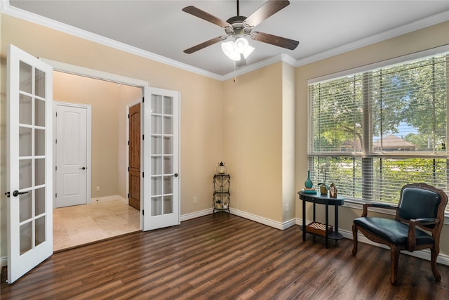 sitting room with wood finished floors, ornamental molding, and french doors
