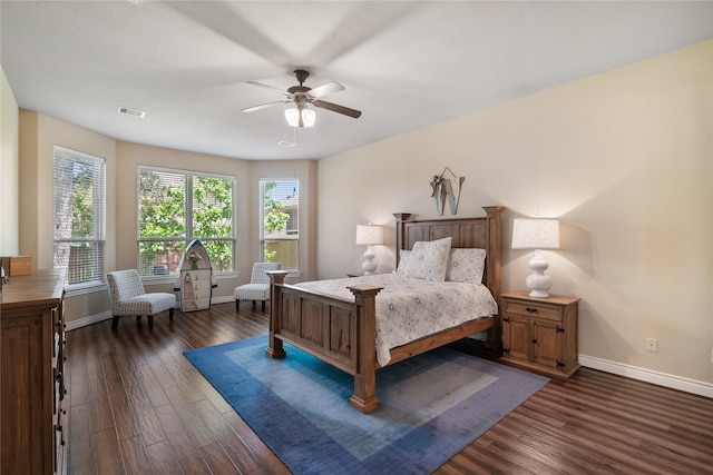 bedroom featuring baseboards, a ceiling fan, visible vents, and dark wood-style floors