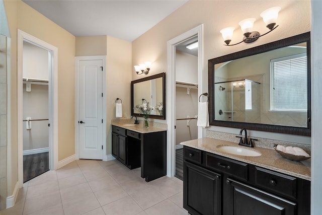 full bathroom with tile patterned flooring, a sink, two vanities, and a tile shower