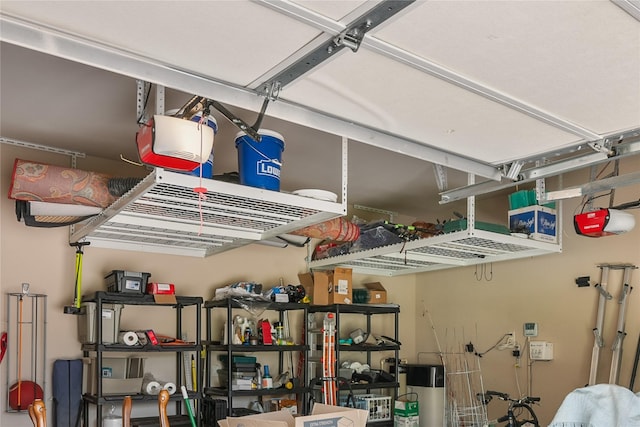 garage with water heater and a garage door opener