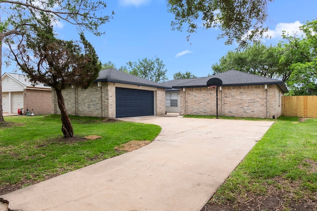 ranch-style house featuring fence, a front lawn, brick siding, a garage, and driveway