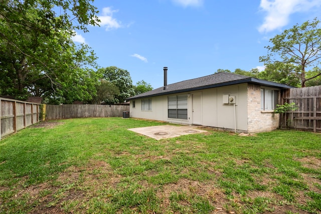 back of house featuring a lawn, a fenced backyard, board and batten siding, and a patio