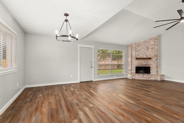 unfurnished living room featuring baseboards, wood finished floors, and ceiling fan with notable chandelier