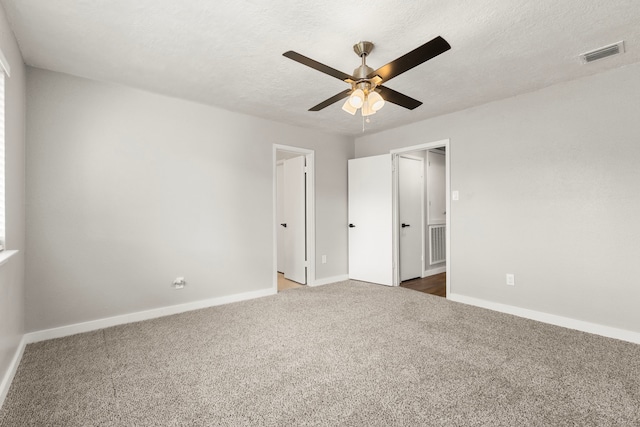unfurnished bedroom with visible vents, carpet, ceiling fan, and baseboards